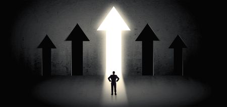 Young businessman with back choosing the best way