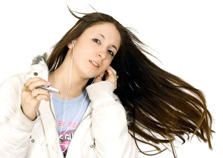 beautiful teenager enjoying her music, shot over white in studio