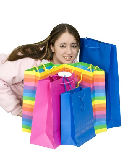 happy teen with her shopping bags over white lying on the floor