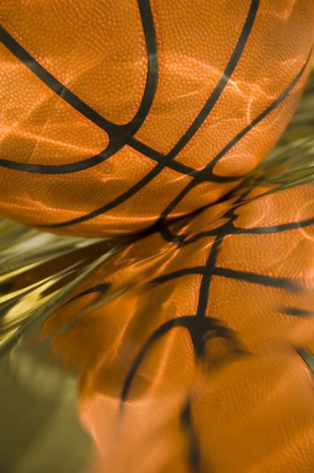Sunlight playing on basketball and its reflection