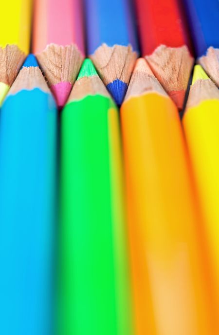 assorted colour pencils close up in perspective with focus on the tips using a shallow depth of field