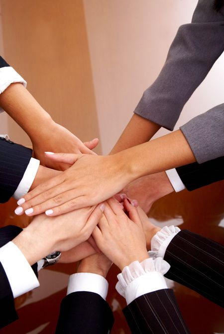 business office team work - hands of successful businessmen and businesswomen together