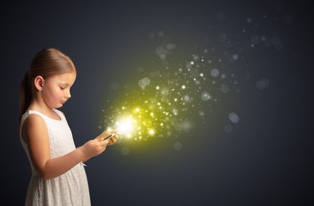 Little cute girl playing on sparkling tablet
