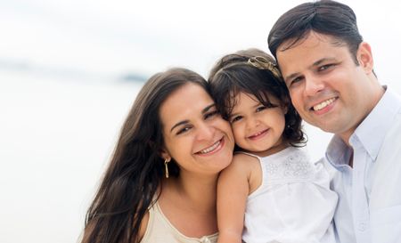 Beautiful family on holidays looking very happy outdoors