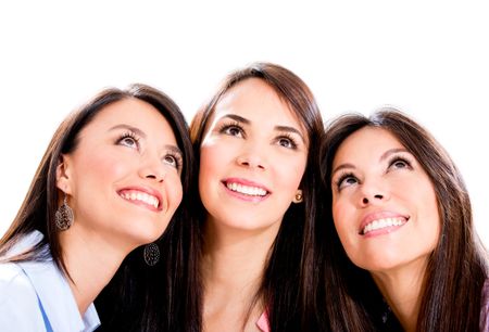 Three pensive women looking up - isolated over a white background