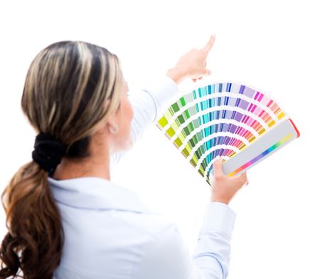 Woman decorating the house and choosing a color for the wall - isolated