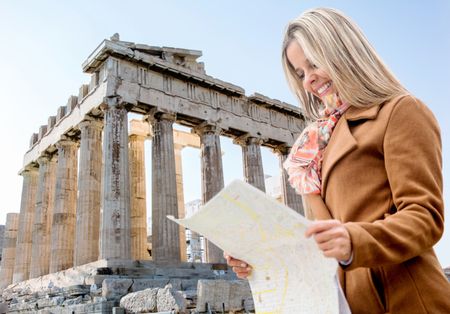 Woman on holidays holding a map in Athens, Greece