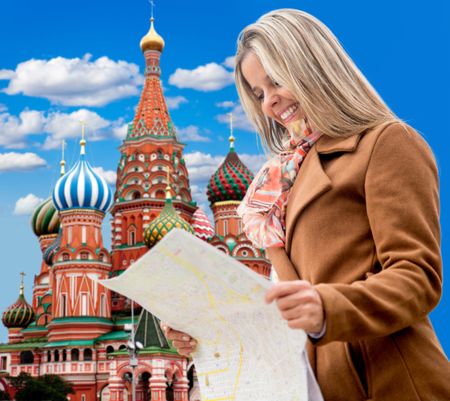 Happy woman seightseeing in Moscow and holding a map