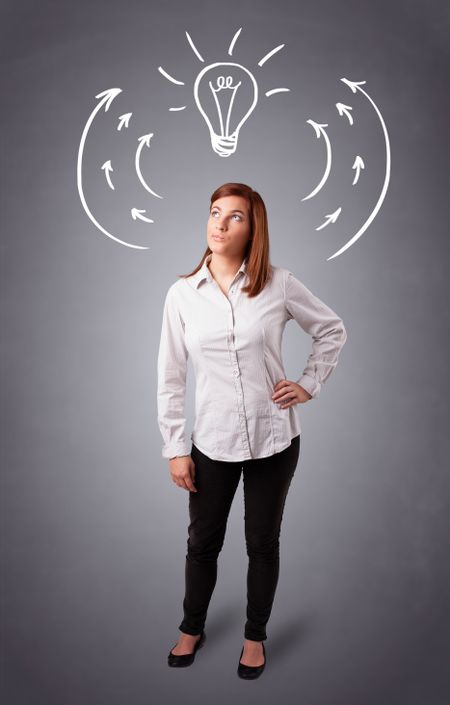 Pretty young lady standing and thinking with arrows and light bulb overhead