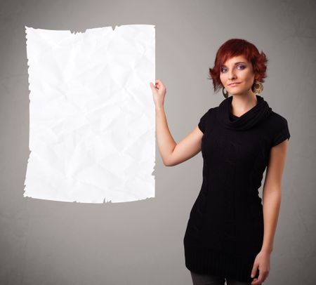 Beautiful young girl holding crumpled white paper copy space