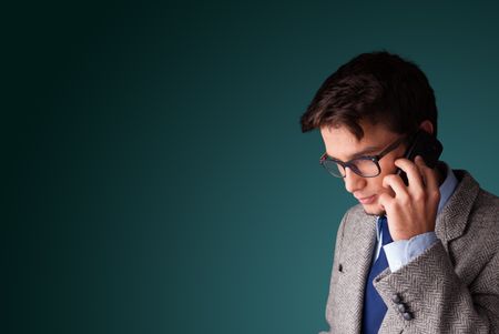Young man standing and making phone call with copy space