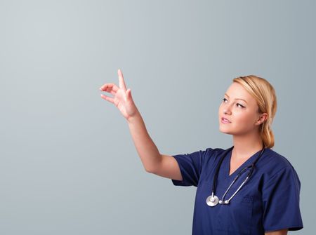 Pretty young female doctor gesturing with copy space