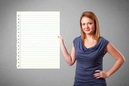 Pretty young lady holding white paper copy space with diagonal lines