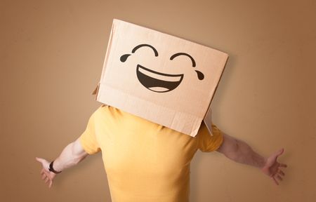 Funny man wearing cardboard box on his head with smiley face