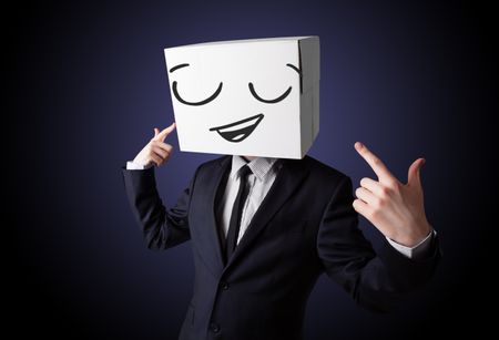 Businessman standing and gesturing with a cardboard box on his head with smiley face