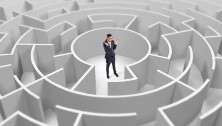 Young businessman standing in a middle of a 3d round maze