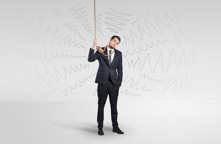 Hopeless young businessman trying to suicide with question signs concept