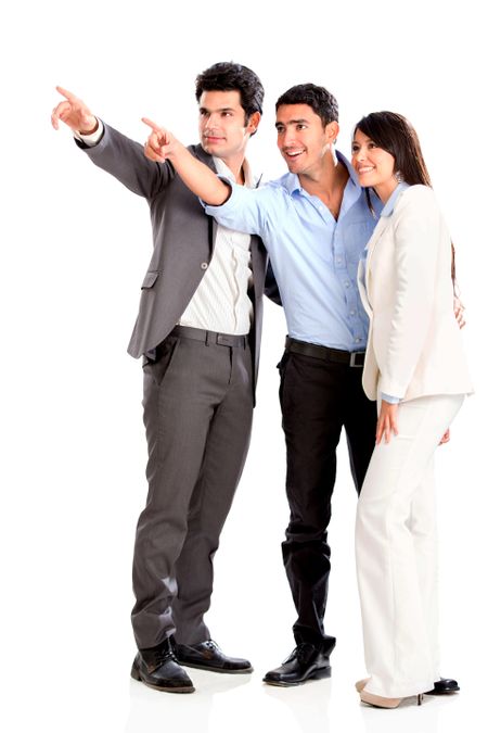 Business group pointing away and smiling - isolated over white background