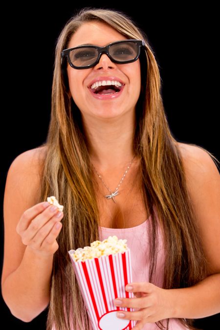 Woman watching a 3D movie with glasses and eating popcorn