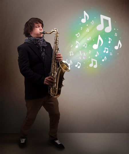 Attractive young musician playing on saxophone while musical notes exploding