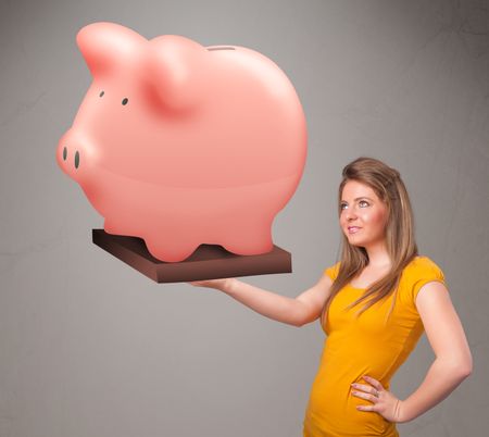 Beautiful young girl holding a huge savings piggy bank