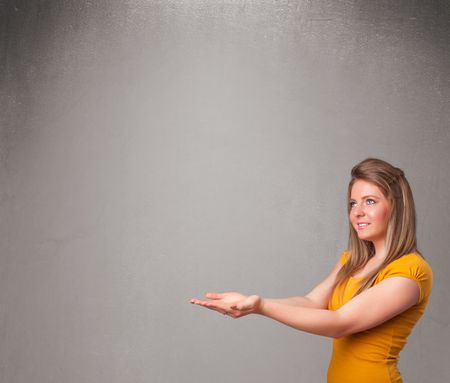 Pretty young woman presenting an empty copy space