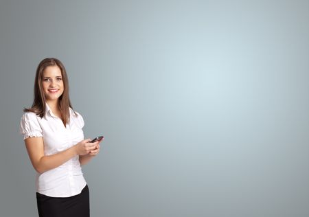 attractive young woman holding a phone with copy space