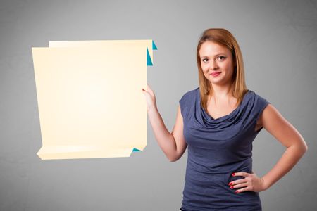 Baeutiful young woman holding white origami paper copy space