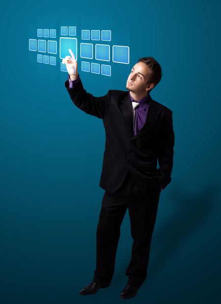 Businessman pressing high tech type of modern buttons on a virtual background