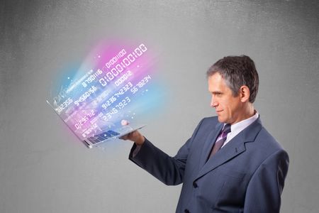 Attractive businessman holding notebook with exploding data and numbers