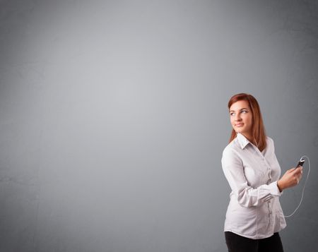 pretty young lady singing and listening to music with copy space