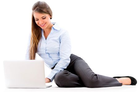 Business woman laying down with a laptop - isolated over a white backgorund