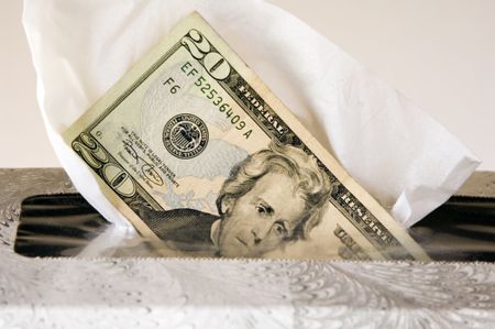 Twenty-dollar bill emerging from box of white tissues
