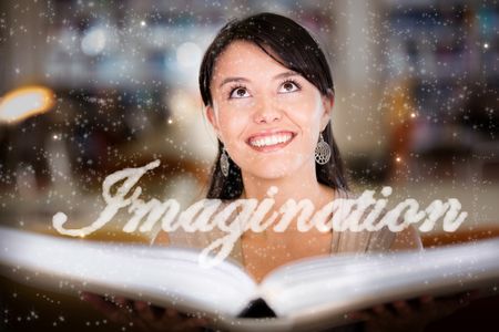 Woman reading a book and letting her imagination fly