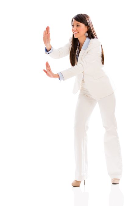 Business woman pushing something with her hands - isolated over white