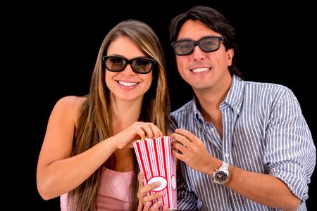 Couple watching movie in 3D - isolated over a black background