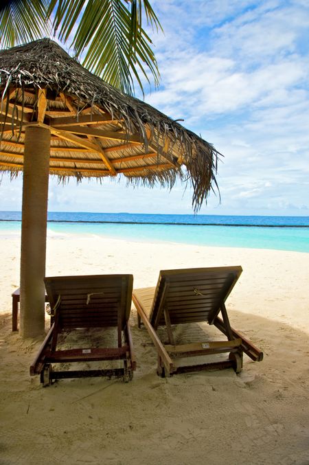 sunchairs and umbrellas in a tropical beach