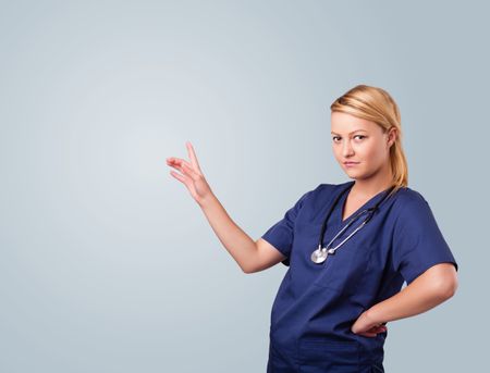 Pretty young female doctor gesturing with copy space