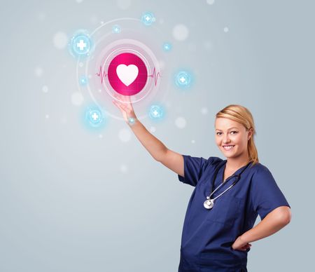 Young nurse standing and pressing modern medical type of buttons