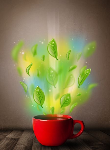 Tea cup with leaves and colorful abstract lights, close up