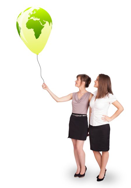Happy young ladies holding a green globe balloon