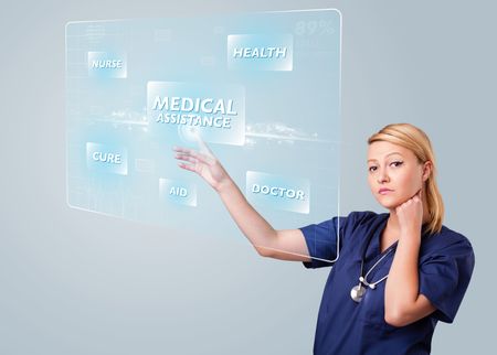 Young nurse standing and pressing modern medical type of buttons