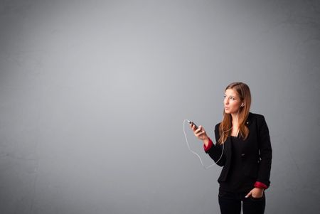 pretty young lady singing and listening to music with copy space