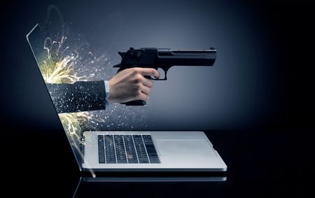 Hand with gun coming out of a laptop with sparkling effects