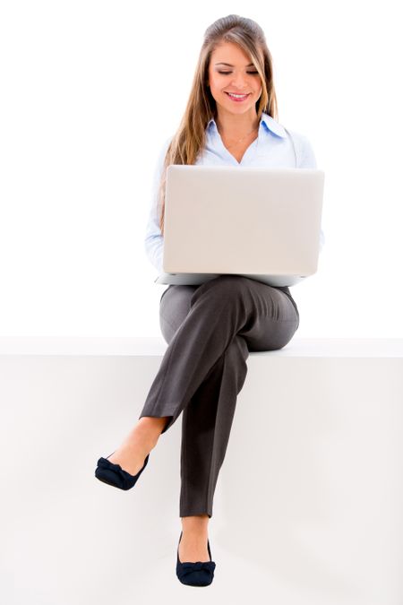 Beautiful businesswoman sitting with a laptop on her legs