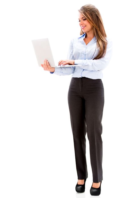 Business woman standing a holding a laptop. Isolated over white