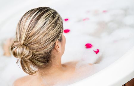 Woman in a spa taking a foam bath