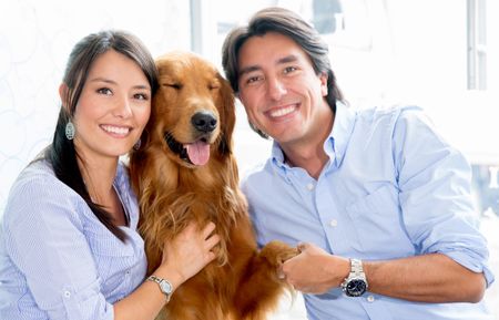 Happy couple holding their dog