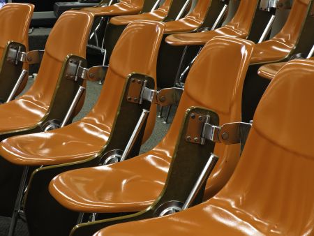 One size fits all: Identical shiny hard orange molded seats in lecture hall