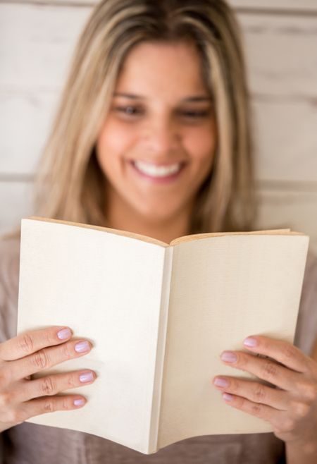 Woman enjoying reading a book at home